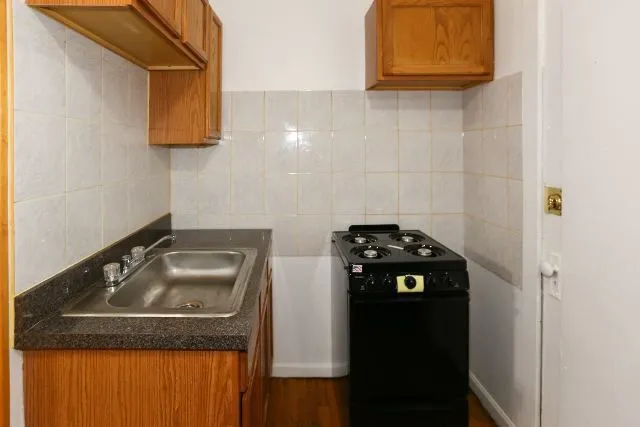 a close up of a sink and a stove top oven