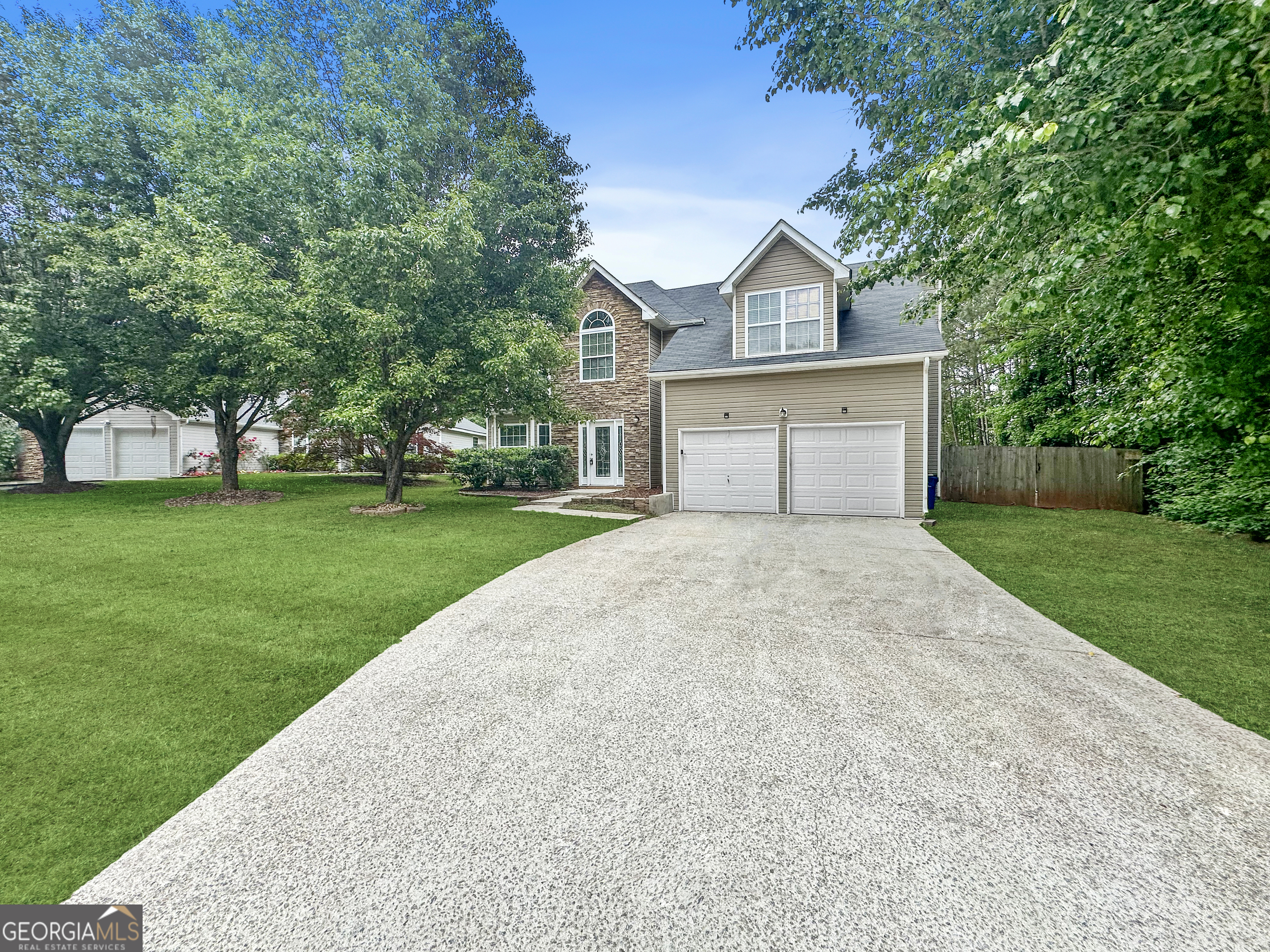 a front view of a house with a yard and garage