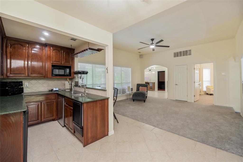 135 Kirkpatrick Road Ennis, TX 75119 - Photo 23 of 40 a large kitchen with stainless steel appliances granite countertop a stove and cabinets