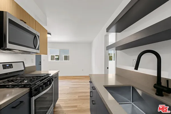 a kitchen with a stove and a microwave