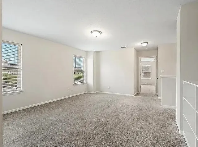 an empty room with windows and closet