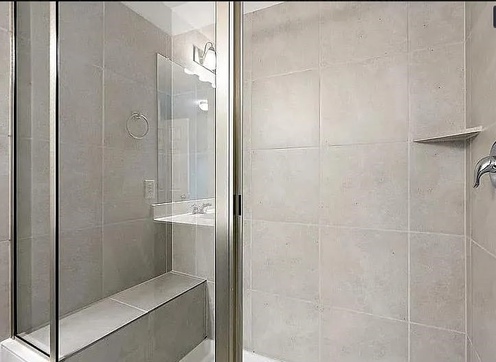 10801 Sentinel Drive Austin, TX 78747 - Photo 21 of 23 a bathroom with a glass shower door