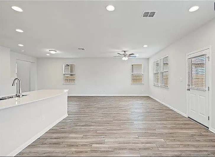10801 Sentinel Drive Austin, TX 78747 - Photo 4 of 23 a view of an empty room with wooden floor and a window