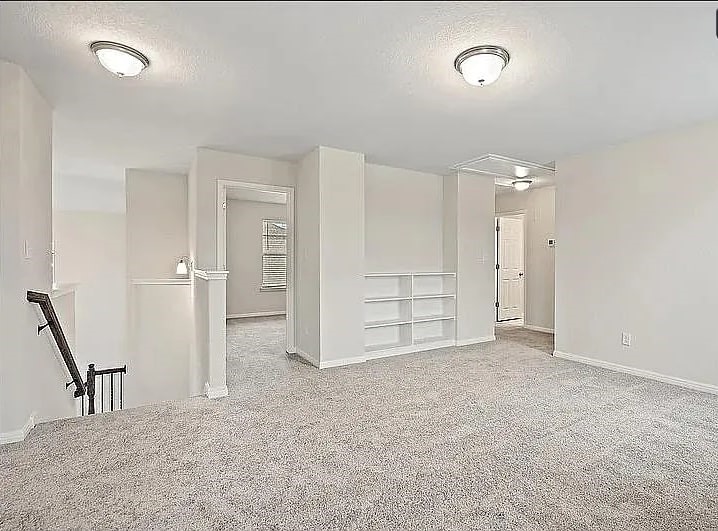10801 Sentinel Drive Austin, TX 78747 - Photo 7 of 23 an empty room with a cabinet and mirrors