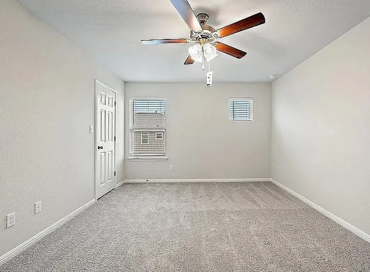 10801 Sentinel Drive Austin, TX 78747 - Photo 8 of 23 an empty room with windows and fan