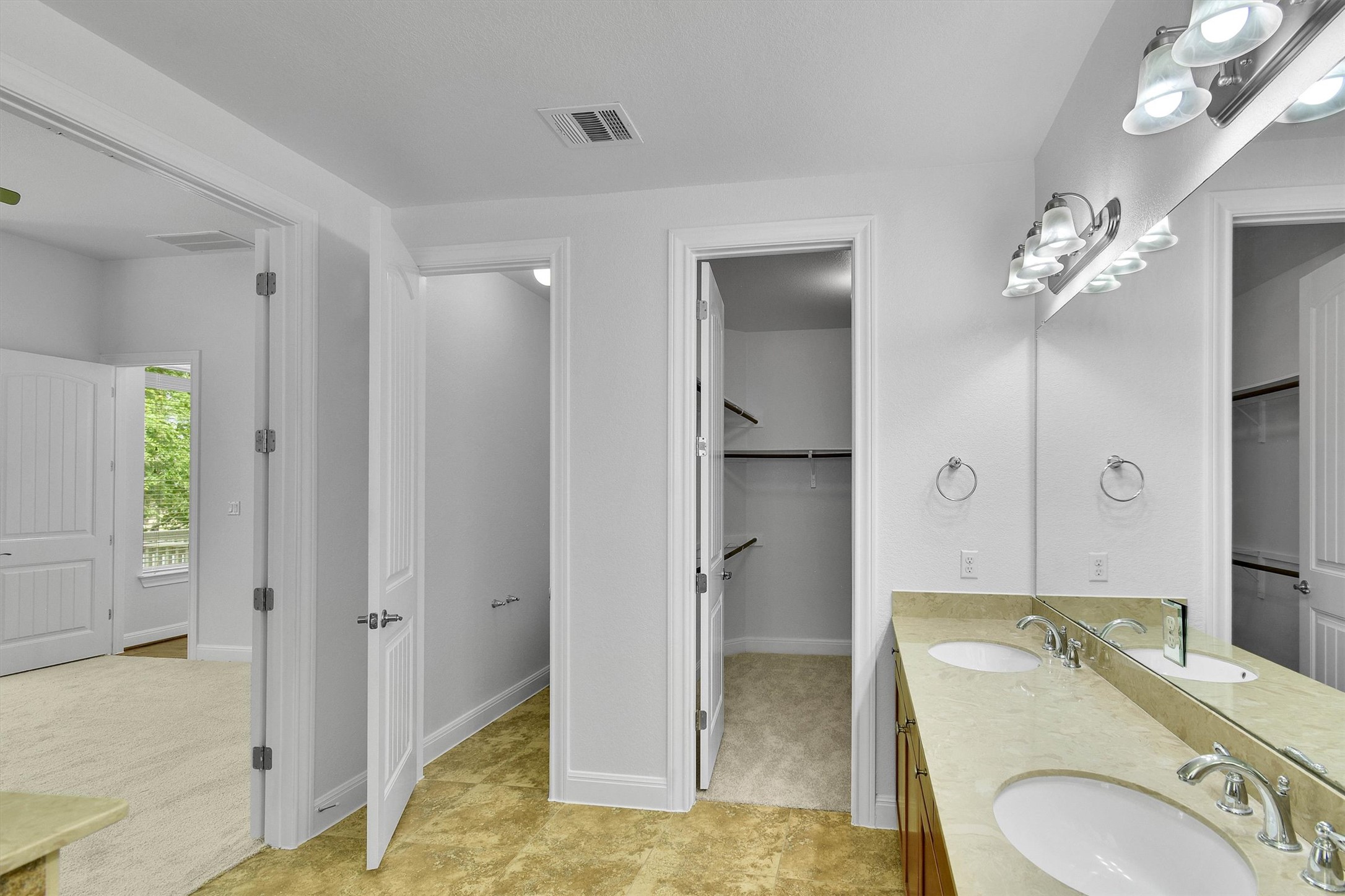2325 Blended Tree Ranch Drive Leander, TX 78641 - Photo 18 of 35 Double vanity and private closet access define this well-appointed primary bathroom.
