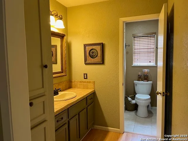 a bathroom with a toilet sink and mirror