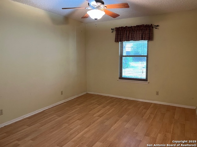 1216 Mocking Bird Circle Pleasanton, TX 78064 - Photo 21 of 31 an empty room with wooden floor and windows