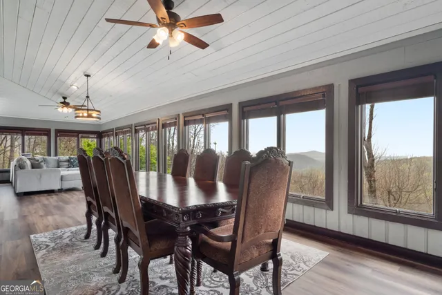 a view of a dining room with furniture window and wooden floor