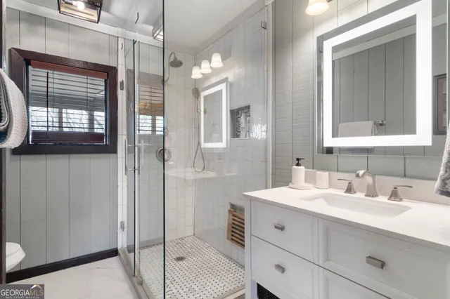 a bathroom with a sink vanity and a mirror