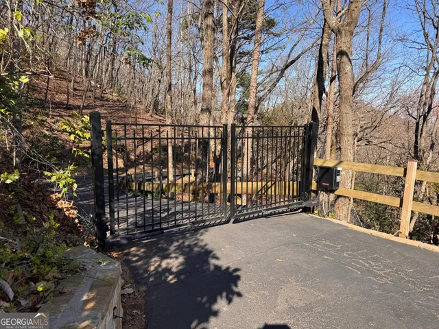 a view of a street with wooden fence