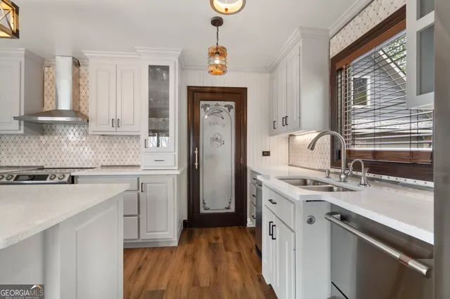a kitchen with a sink stove and cabinets