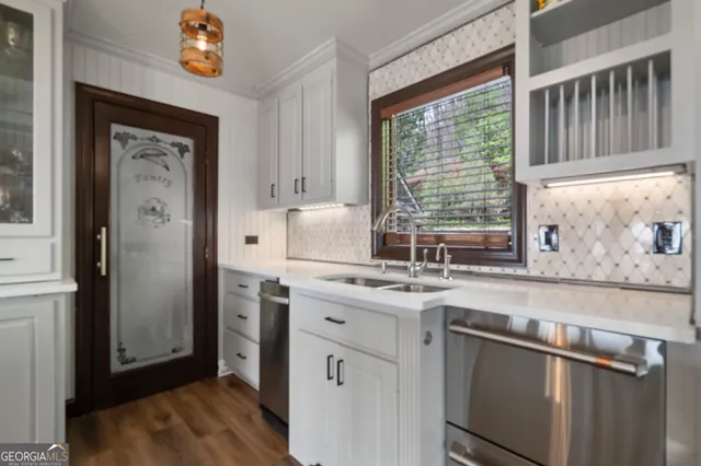 a kitchen with stainless steel appliances granite countertop a refrigerator and a sink