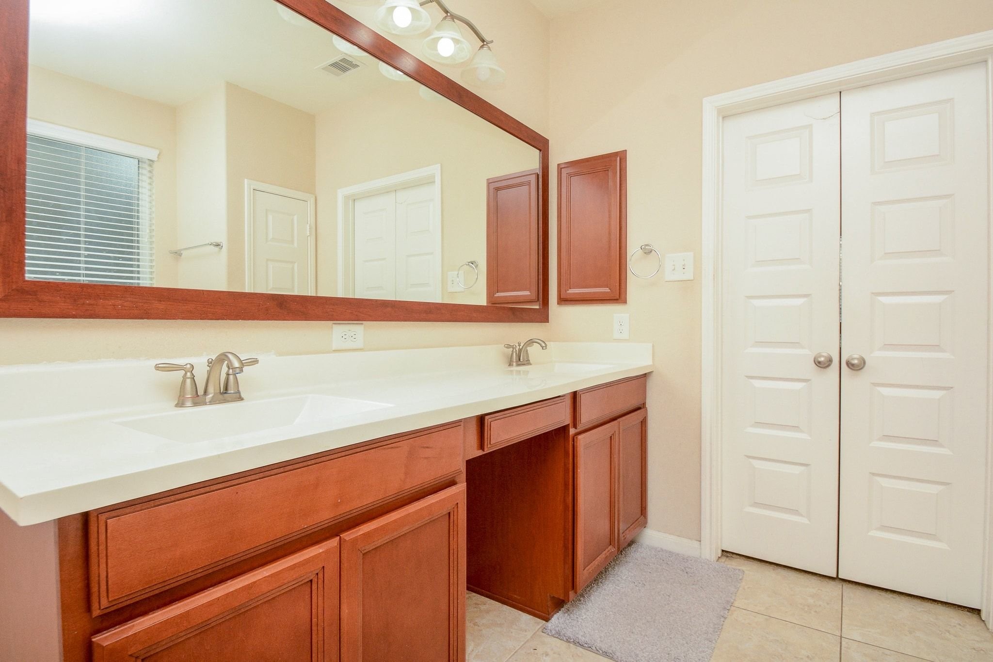 7046 Sliding Rock Circle Spring, TX 77379 - Photo 19 of 41 Dual sinks with elegant fixtures and generous storage in the primary bathroom.