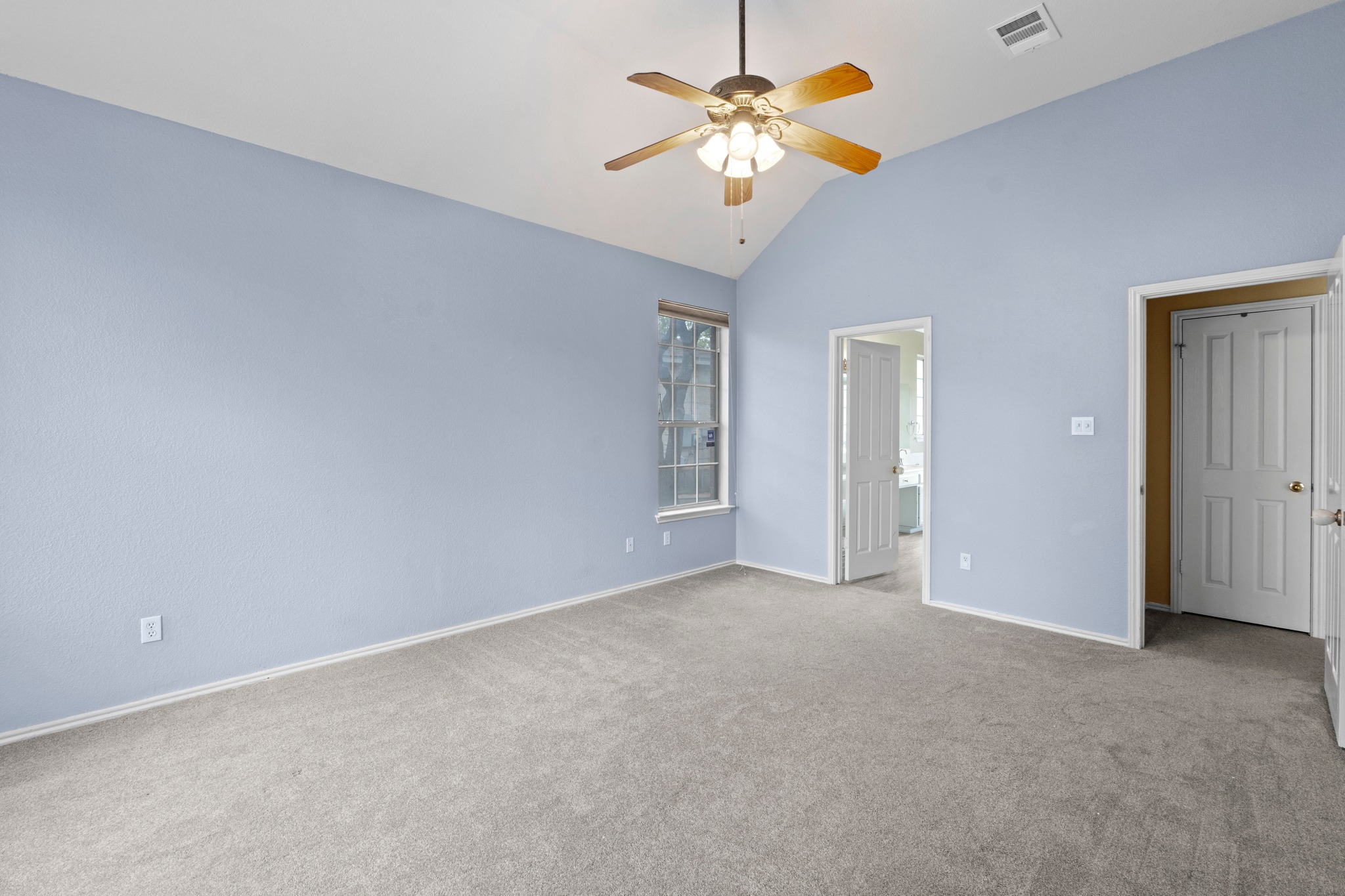 8605 Axis Drive Austin, TX 78749 - Photo 18 of 38 A spacious room features a vaulted ceiling, providing an open and airy atmosphere.