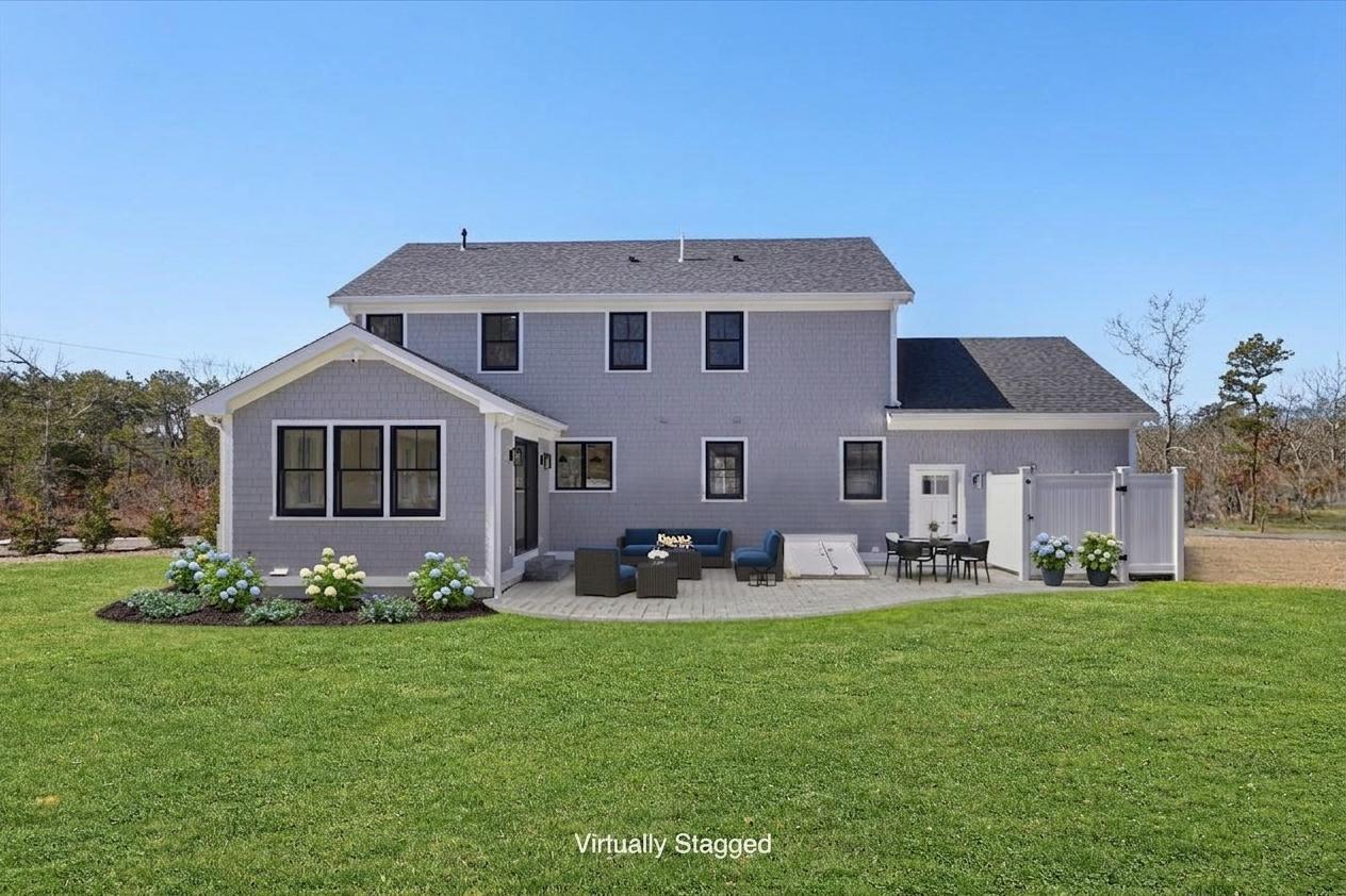 58 Old Chatham Road Brewster, MA 02631 - Photo 18 of 43 a front view of a house with a garden and plants
