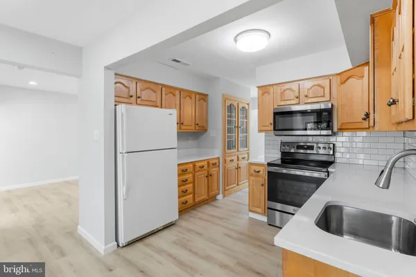 a kitchen with a refrigerator sink and stove