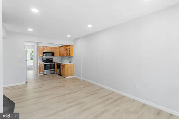 a view of kitchen with furniture and wooden floor