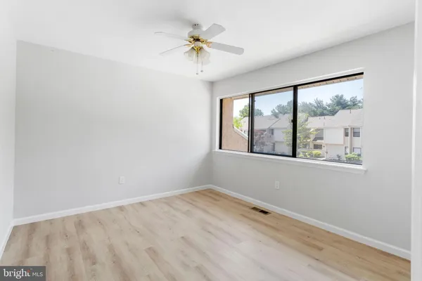 a view of an empty room with a fan