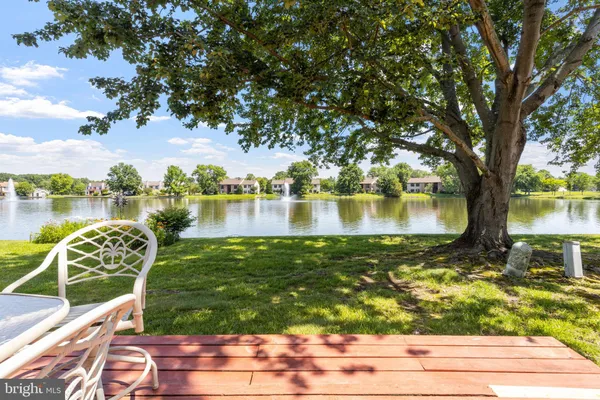 a view of a lake with houses in the back