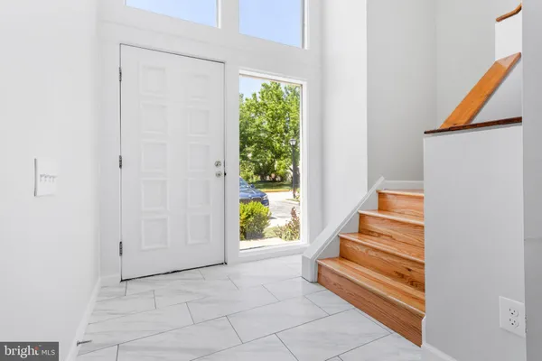 a view of entryway and hall with wooden floor