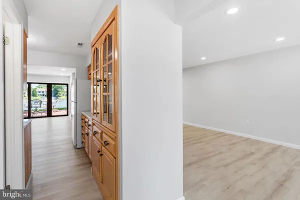a view of a hallway with wooden floor and windows
