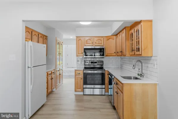 a kitchen with stainless steel appliances granite countertop a refrigerator and a sink