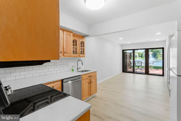 a kitchen with a sink and a stove top oven