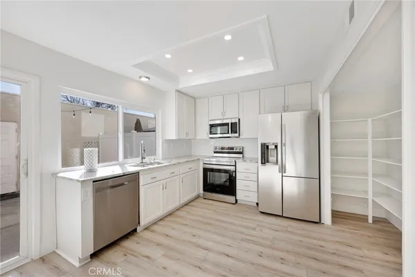 a kitchen with a sink stainless steel appliances and cabinets