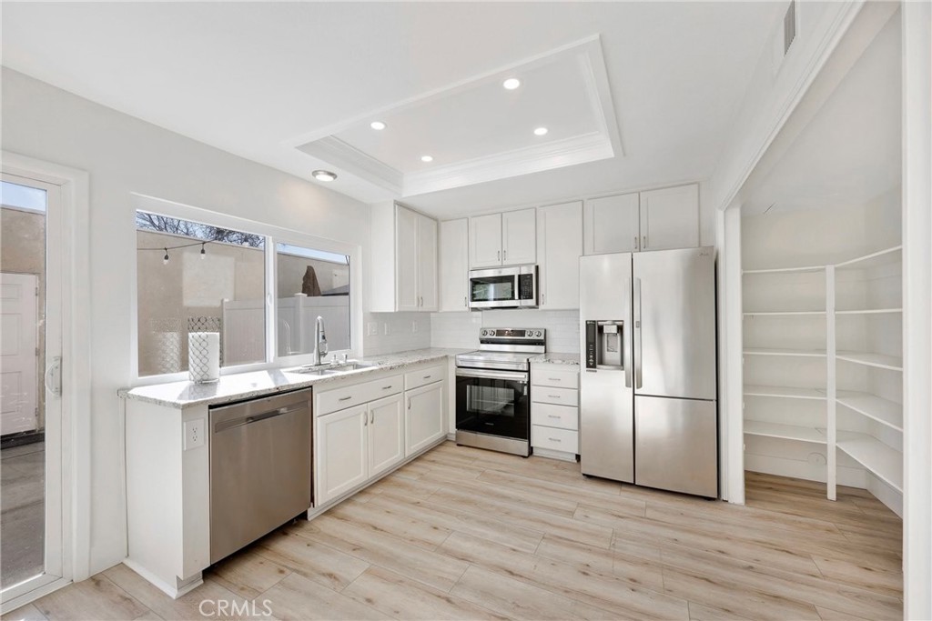 a kitchen with a sink stainless steel appliances and cabinets