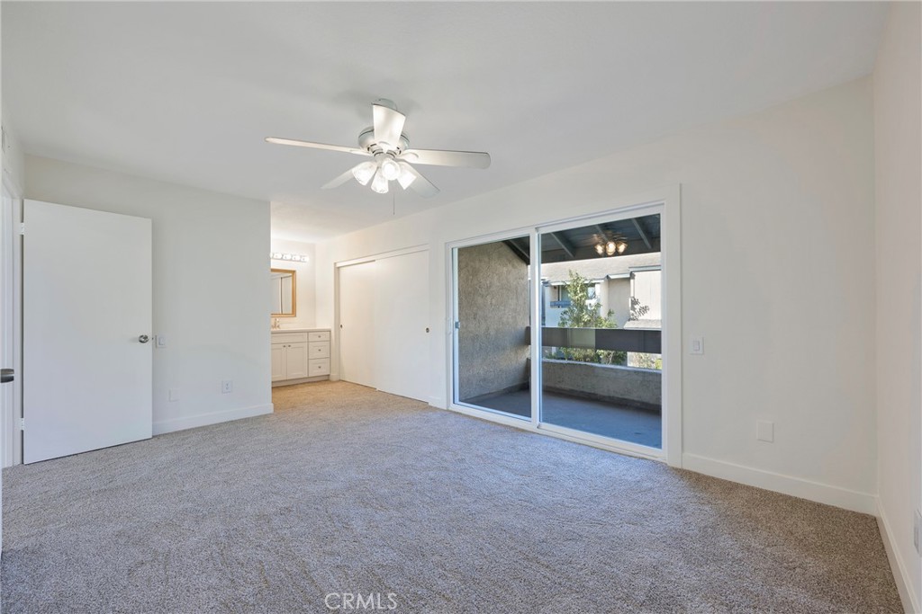 598 Elkwood Court Brea, CA 92821 - Photo 11 of 32 an empty room with chandelier fan and kitchen view