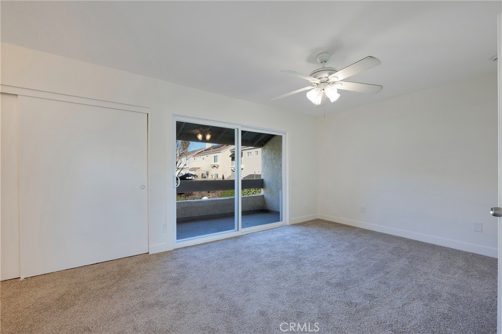 598 Elkwood Court Brea, CA 92821 - Photo 15 of 32 an empty room with chandelier fan and kitchen view