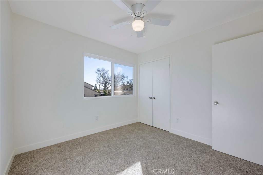598 Elkwood Court Brea, CA 92821 - Photo 18 of 32 an empty room with a window and ceiling fan