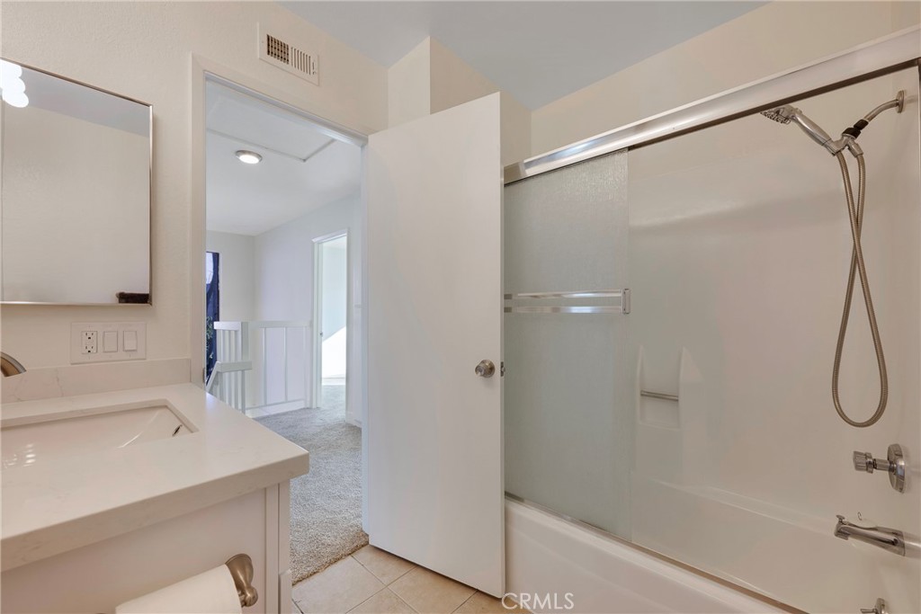 598 Elkwood Court Brea, CA 92821 - Photo 20 of 32 a bathroom with a sink a shower and a mirror