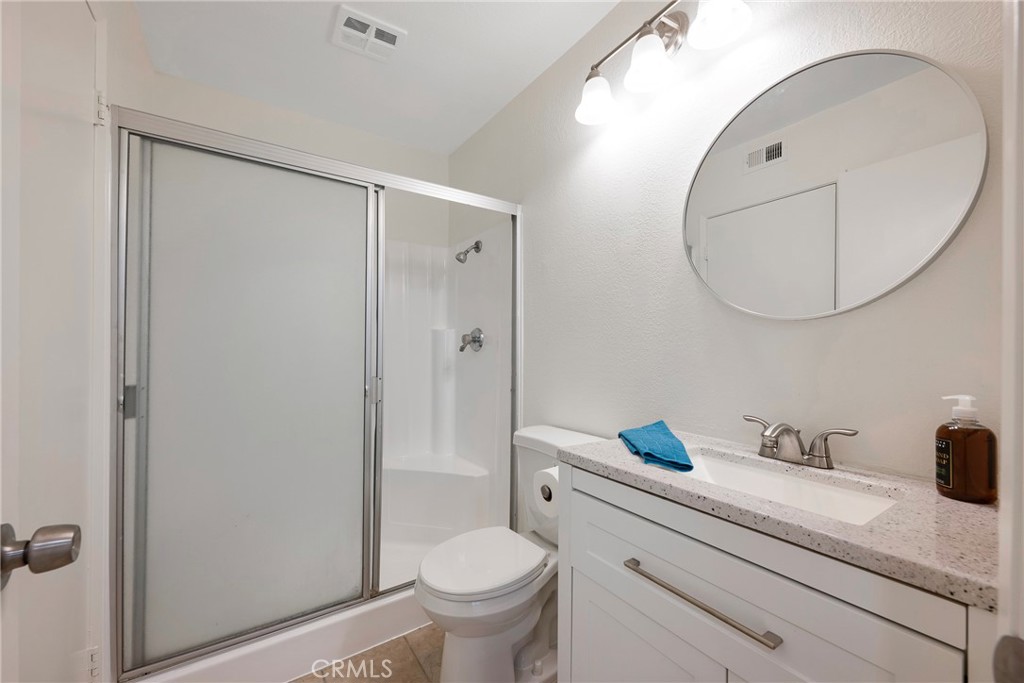 598 Elkwood Court Brea, CA 92821 - Photo 21 of 32 a bathroom with a sink a toilet and a mirror