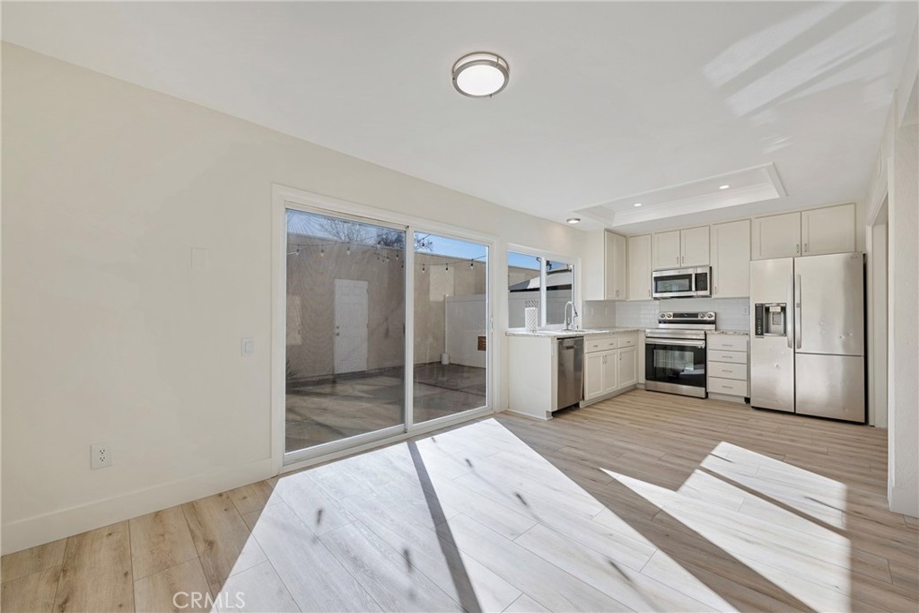 598 Elkwood Court Brea, CA 92821 - Photo 5 of 32 a view of a kitchen with wooden floor and electronic appliances