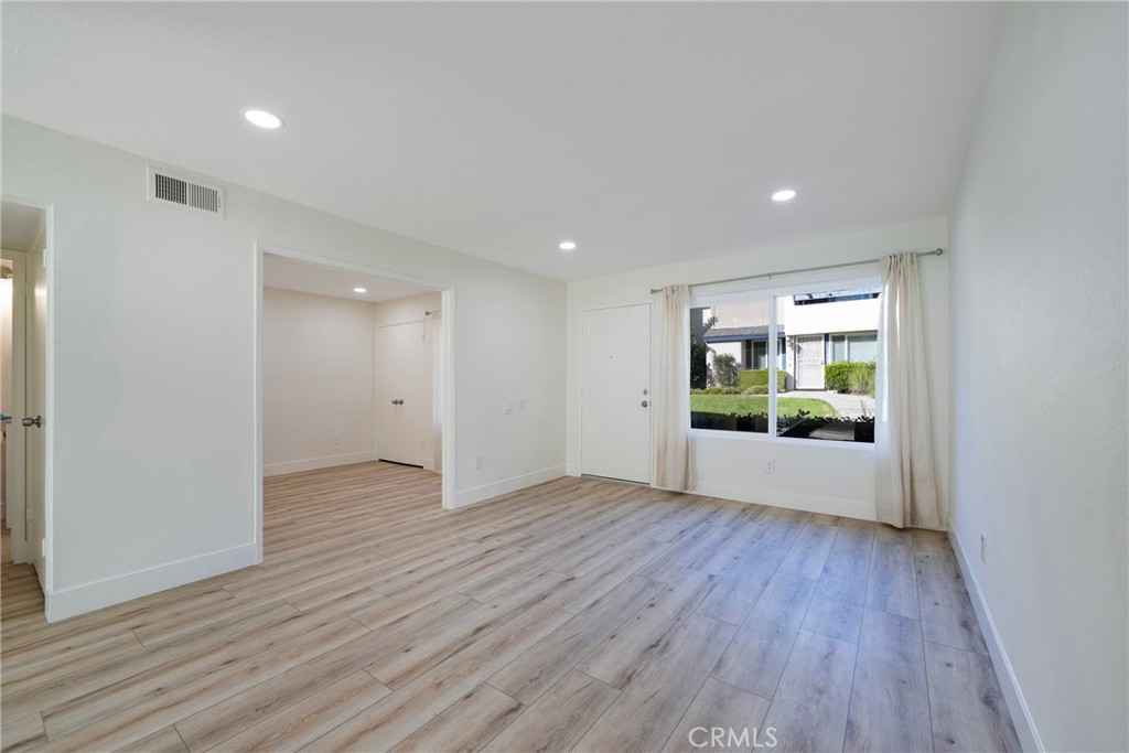 598 Elkwood Court Brea, CA 92821 - Photo 9 of 32 a view of an empty room with wooden floor and a window