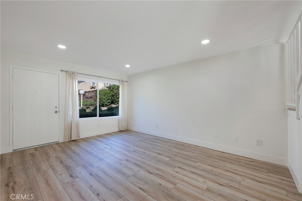 598 Elkwood Court Brea, CA 92821 - Photo 10 of 32 a view of an empty room with wooden floor and a window