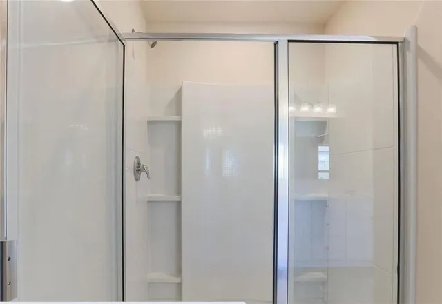 a bathroom with a glass shower door