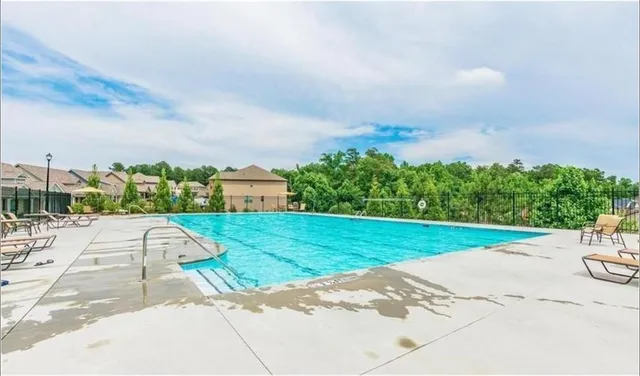 a view of a swimming pool with a yard