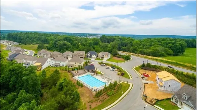 an aerial view of a house with garden space and street view