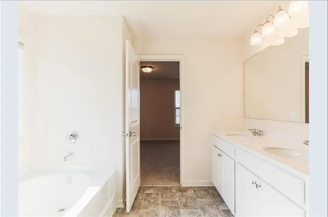a bathroom with a bathtub and a sink