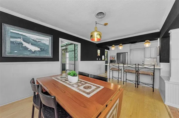 a view of a dining room with furniture and wooden floor