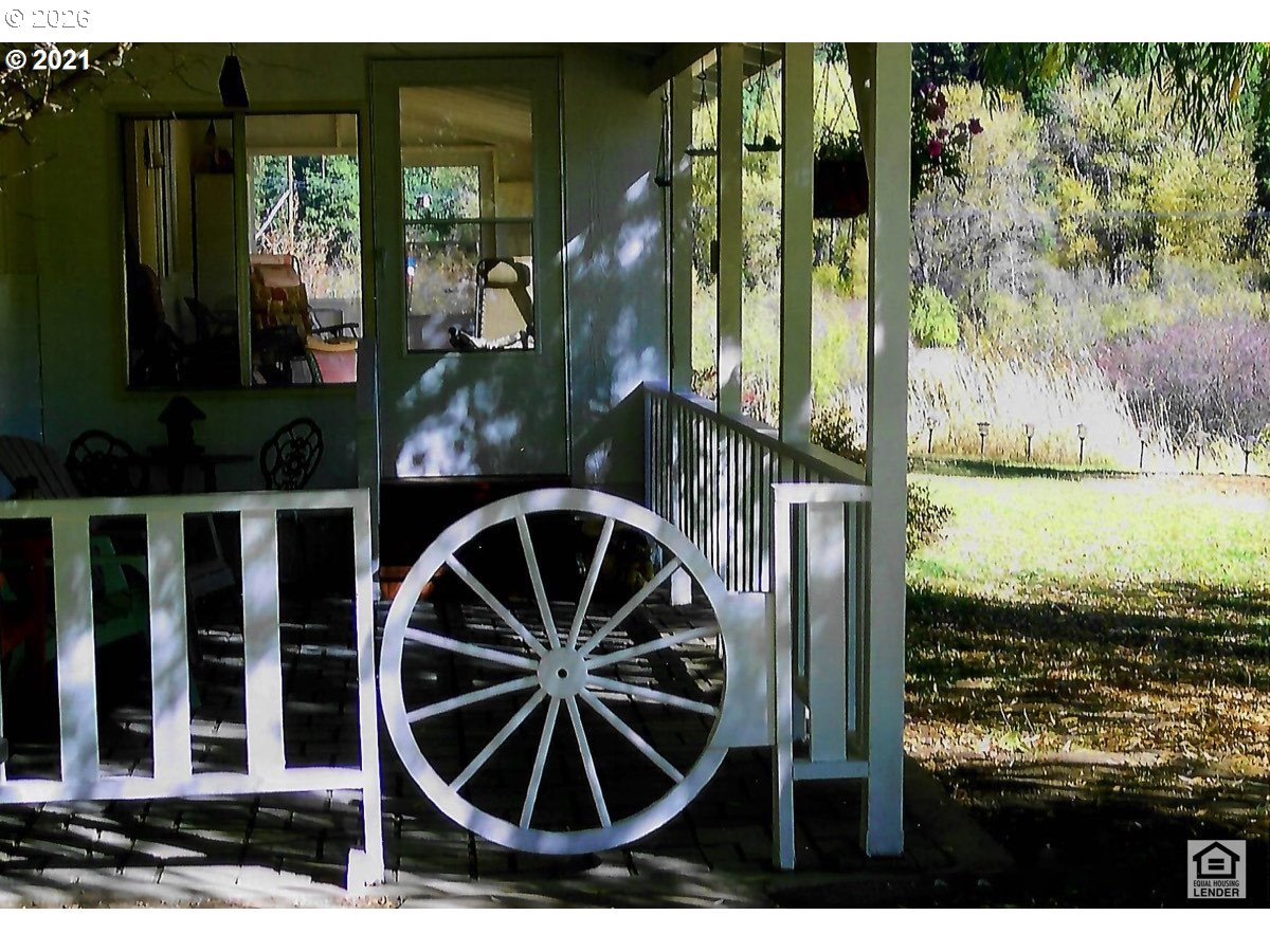 59099 Upper Imnaha Road Imnaha, OR 97842 - Photo 3 of 18 a view of a porch with a floor to ceiling window and tree