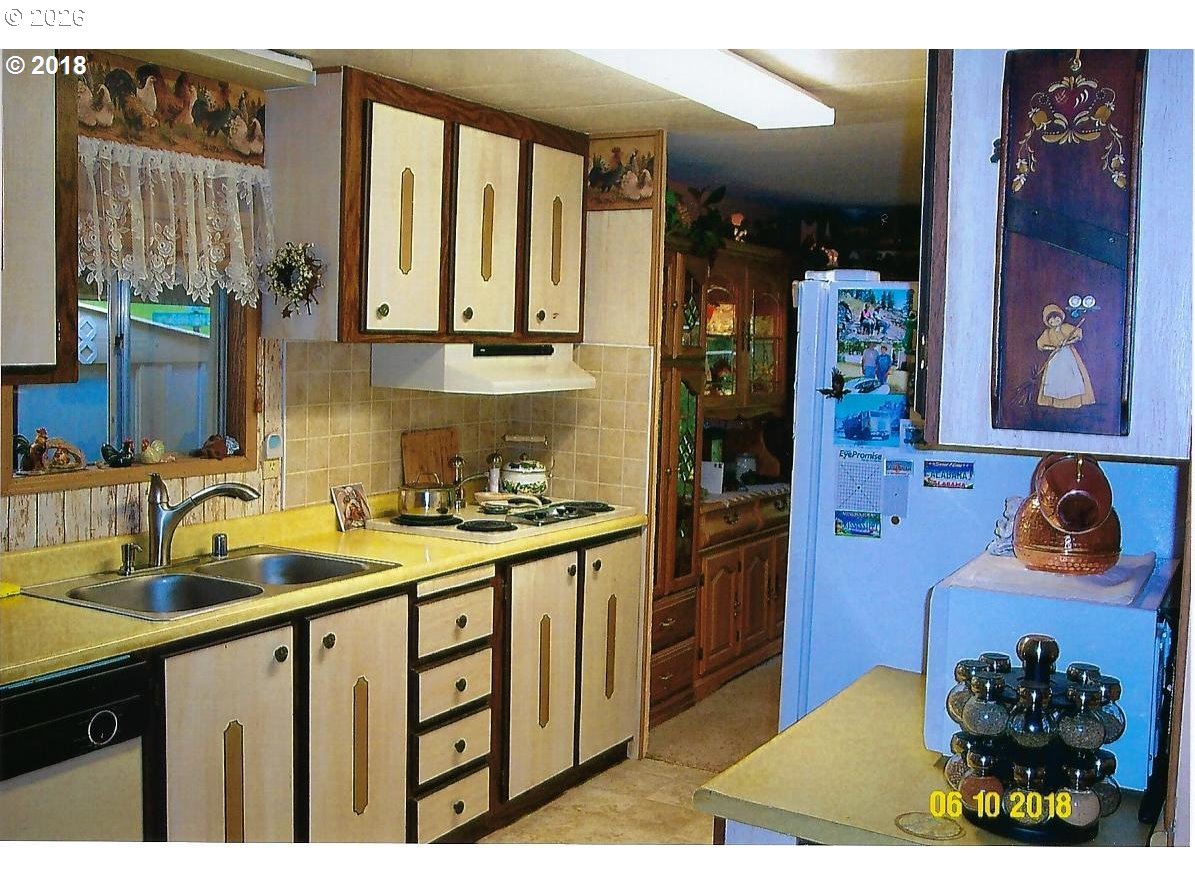 59099 Upper Imnaha Road Imnaha, OR 97842 - Photo 10 of 18 a kitchen with stainless steel appliances granite countertop a sink stove and cabinets