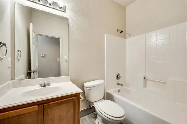 a bathroom with a sink toilet vanity and shower