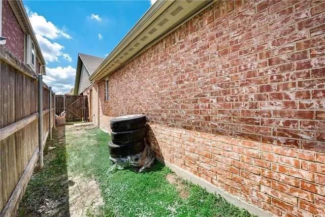 a backyard of a house with barbeque oven