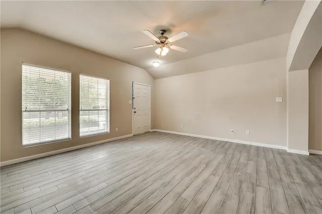 wooden floor in an empty room with a window