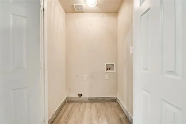 a view of a room with wooden floor and a shower