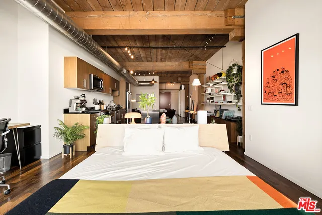 a large white room with kitchen view